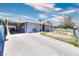 Single story home featuring a long driveway, desert landscaping, and a covered area for parking at 1112 Sandy Cove St, Las Vegas, NV 89110