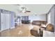 Expansive living room featuring tile flooring, multiple ceiling fans, and a view into the kitchen and dining area at 1112 Sandy Cove St, Las Vegas, NV 89110