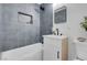 Modern bathroom with stylish gray tiling, sleek fixtures, and a soaking tub at 1115 W Nelson Ave, North Las Vegas, NV 89030