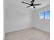 Bright, minimalist bedroom with light wood floors and a window showcasing the clear sky at 1115 W Nelson Ave, North Las Vegas, NV 89030
