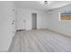 Bright bedroom features closet, light wood floors, and modern lighting at 1115 W Nelson Ave, North Las Vegas, NV 89030