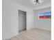 Bright bedroom features closet, light wood floors, and a window showcasing the neighborhood at 1115 W Nelson Ave, North Las Vegas, NV 89030