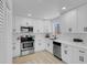 Bright kitchen features white cabinets, stainless steel appliances, and modern countertops at 1115 W Nelson Ave, North Las Vegas, NV 89030