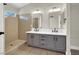 Bathroom featuring a double sink vanity, shower and modern fixtures at 1225 Stonesthrow Cir, North Las Vegas, NV 89031