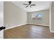 Spacious bedroom featuring ceiling fan, wood-look vinyl flooring, and natural light at 1225 Stonesthrow Cir, North Las Vegas, NV 89031