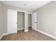 This bedroom has wood-look floors and a closet for storage at 1225 Stonesthrow Cir, North Las Vegas, NV 89031