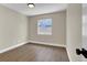 An empty bedroom with wood-look floors and a window at 1225 Stonesthrow Cir, North Las Vegas, NV 89031