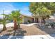 Beautiful single-story home with desert landscaping including palm trees and shrubs at 1225 Stonesthrow Cir, North Las Vegas, NV 89031