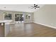 Bright open living area with wood-look floors and sliding glass doors to the backyard at 1225 Stonesthrow Cir, North Las Vegas, NV 89031