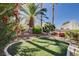 This backyard features manicured landscaping, an artificial lawn and a hot tub for relaxation and enjoyment at 1333 Date Palm Cir, Las Vegas, NV 89108