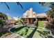 Secluded backyard featuring a spa, lush greenery, and a covered patio at 1333 Date Palm Cir, Las Vegas, NV 89108