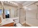 Standard bathroom featuring a vanity, toilet, frosted glass shower door and large mirror with vanity lighting at 1333 Date Palm Cir, Las Vegas, NV 89108