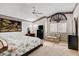 Bright bedroom featuring a floral bedspread, ceiling fan, tapestry, and carpeted floor with natural light at 1333 Date Palm Cir, Las Vegas, NV 89108