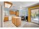 Bright kitchen with light wood cabinets, an island, and a cozy breakfast nook at 1333 Date Palm Cir, Las Vegas, NV 89108