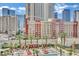 Beautiful aerial view of a pool, outdoor lounge areas, and the city skyline at 135 E Harmon Ave # 315, Las Vegas, NV 89109