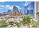 Stunning aerial view of a pool, sun loungers, and the vibrant cityscape at 135 E Harmon Ave # 315, Las Vegas, NV 89109
