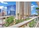 Serene balcony view overlooking lush landscaping and towering buildings in a prime location at 135 E Harmon Ave # 315, Las Vegas, NV 89109