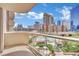 Picturesque balcony overlooking a sparkling pool and vibrant cityscape on a sunny day at 135 E Harmon Ave # 315, Las Vegas, NV 89109