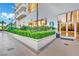 Exterior entrance adorned with lush landscaping, Starbucks logo, and inviting glass doors, blending nature and convenience at 135 E Harmon Ave # 315, Las Vegas, NV 89109