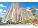 Stunning exterior shot showcasing the buildings and pool area on a beautiful day at 135 E Harmon Ave # 315, Las Vegas, NV 89109