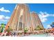 Striking exterior view of a high-rise building with numerous balconies against a bright blue sky at 135 E Harmon Ave # 315, Las Vegas, NV 89109