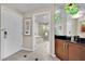 Hallway view including bathroom with large tub and shower, plus a glimpse of tasteful decor and modern fixtures at 135 E Harmon Ave # 315, Las Vegas, NV 89109