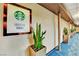 Hallway with Starbucks signage, snake plants and blue carpet with a geometric design at 135 E Harmon Ave # 315, Las Vegas, NV 89109