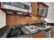 This well-equipped kitchenette features sleek black countertops and contemporary appliances for a convenient cooking experience at 135 E Harmon Ave # 315, Las Vegas, NV 89109
