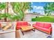Outdoor lounge area with two red sofas, a wooden table, and a fire pit at 135 E Harmon Ave # 315, Las Vegas, NV 89109