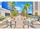 Beautiful pool area with lush palm trees, seating areas, and a view of the city skyline at 135 E Harmon Ave # 315, Las Vegas, NV 89109