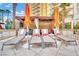 Relaxing pool loungers under shaded umbrellas and cabana, offering a serene and luxurious experience at 135 E Harmon Ave # 315, Las Vegas, NV 89109