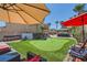 Backyard putting green, lounge chairs, covered seating, and desert landscaping at 1701 Drifters Peak St, Las Vegas, NV 89144