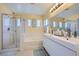 Bright bathroom with double vanity, walk-in shower with glass door, and soaking tub at 1701 Drifters Peak St, Las Vegas, NV 89144