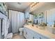 Modern bathroom with white vanity, shower with curtain, and stylish decor at 1701 Drifters Peak St, Las Vegas, NV 89144
