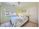 Inviting bedroom with bright green walls, natural light, and a comfortable Queen bed with bedside tables at 1701 Drifters Peak St, Las Vegas, NV 89144