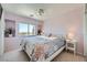 Cozy bedroom with lilac walls, decorative plants, and comfortable Queen bed with bedside tables at 1701 Drifters Peak St, Las Vegas, NV 89144