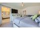 Comfortable bedroom featuring ensuite bathroom access, TV, and soft, patterned bedding at 1701 Drifters Peak St, Las Vegas, NV 89144