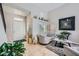 Open-concept living room with tile floors, modern decor, and lots of natural light at 1701 Drifters Peak St, Las Vegas, NV 89144