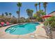 Backyard sparkling swimming pool with mature desert landscaping and covered seating at 1701 Drifters Peak St, Las Vegas, NV 89144