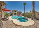 Sparkling pool with spa, lounge chairs, covered seating, and mature desert landscaping at 1701 Drifters Peak St, Las Vegas, NV 89144