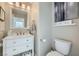 Cozy powder room with white vanity, marble countertop, and elegant decorative accents at 1701 Drifters Peak St, Las Vegas, NV 89144