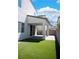Backyard featuring artificial grass, a covered patio, and block wall fence at 1703 Game Garden Rd, North Las Vegas, NV 89031