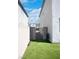 Backyard featuring artificial grass, a pathway and gate to the pool with stucco walls on either side at 1703 Game Garden Rd, North Las Vegas, NV 89031