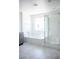 Bathroom with a glass-enclosed shower and tub offers modern comfort and style at 1703 Game Garden Rd, North Las Vegas, NV 89031