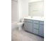 Modern bathroom with a gray vanity, dual sinks, toilet and a shower featuring tiled walls and flooring at 1703 Game Garden Rd, North Las Vegas, NV 89031