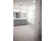 Bathroom features dual vanities, gray cabinets, and a separate tub for relaxation at 1703 Game Garden Rd, North Las Vegas, NV 89031