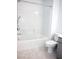 Bathroom with white tub, shower, and toilet creates a clean, modern design at 1703 Game Garden Rd, North Las Vegas, NV 89031