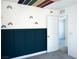 A stylish bedroom showcasing a modern dark blue paneled wall and colorful rainbow wall decals at 1703 Game Garden Rd, North Las Vegas, NV 89031