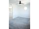 Bright bedroom with neutral walls, gray carpet, ceiling fan, and round window at 1703 Game Garden Rd, North Las Vegas, NV 89031