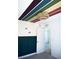 A stylish bedroom showcasing a modern dark blue paneled wall and colorful rainbow wall decals on the ceiling at 1703 Game Garden Rd, North Las Vegas, NV 89031
